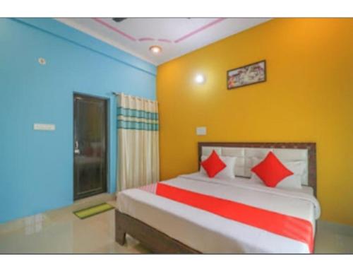 a bedroom with a large bed with red pillows at Morning Mist Homestay, Lansdowne in Lansdowne