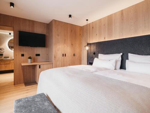 a hotel room with two beds and a flat screen tv at Hotel Oberforsthof in Sankt Johann im Pongau