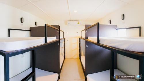 a room with two bunk beds in it at The Train Hotel Hatyai in Hat Yai