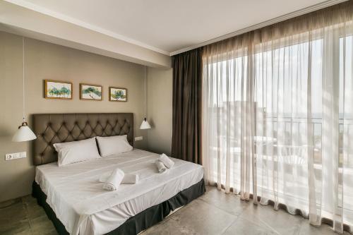 a bedroom with a bed and a large window at Sea lounge in Varna City