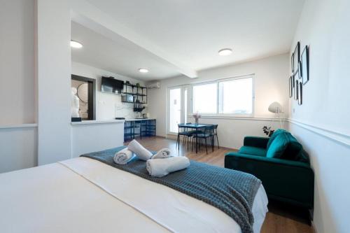 a bedroom with a bed and a couch and a kitchen at Guest house AllineedDubrovnik Choose between Double room or penthouse or studio apartments FREE PARKING in Dubrovnik