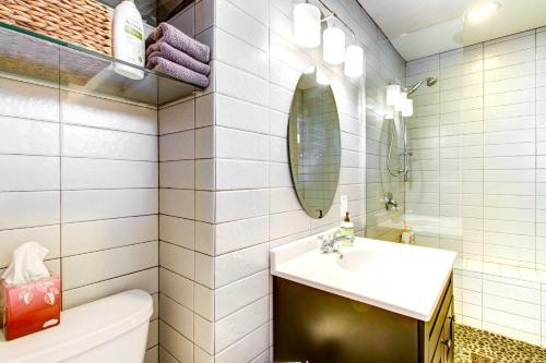 a bathroom with a sink and a toilet and a mirror at Lakefront Walker Home with Boat Dock and Lift! in Walker