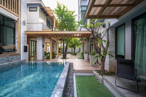 a swimming pool in the backyard of a house at SHAN Villas Sukhumvit in Bangkok