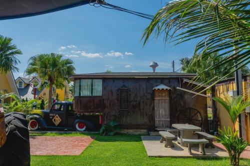 a house with a truck parked in front of it at Apinya Resort Bangsarey in Ban Tao Than