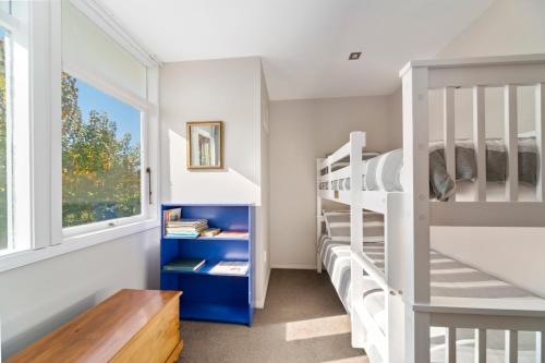 a room with bunk beds and a window at The Orchard House - Turangi Holiday Home in Turangi
