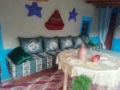 a living room with a couch and a table at auberge yeswal aoulad yaakoube 