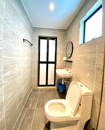 a bathroom with a toilet and a sink at Kuala Selangor Modern Homestay with Pool 20pax in Kuala Selangor