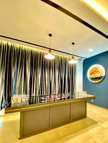 a restaurant with a large window with curtains at Kuala Selangor Modern Homestay with Pool 20pax in Kuala Selangor