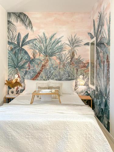 a bedroom with a bed with a mural of palm trees at Americana Beach House in Rimini