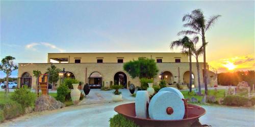 a building with a statue in front of it at Agriturismo Paradiso in Parabita