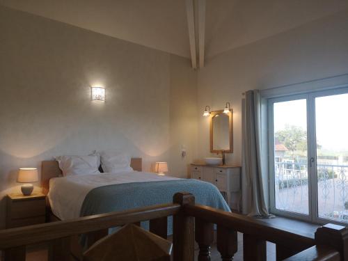 a bedroom with a bed and a large window at La Tour D'Elaine in Essertenne