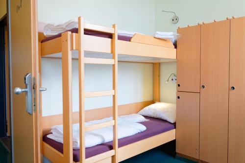 a bunk bed room with two bunk beds at Jugendgästehaus Brigittenau &Brigittenau Youth Palace in Vienna