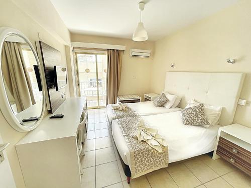 a hotel room with a bed and a couch at Antonis G. Hotel Apartments in Voroklini