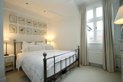 a bedroom with a bed and a window at Central Knutsford in Knutsford