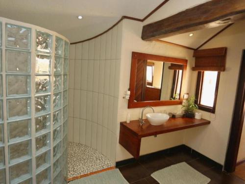 a bathroom with a sink and a mirror at Desert Breeze Lodge in Swakopmund