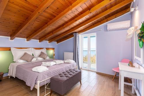 a bedroom with a large bed and a wooden ceiling at Villa Olive Tree by Estia in Benitses