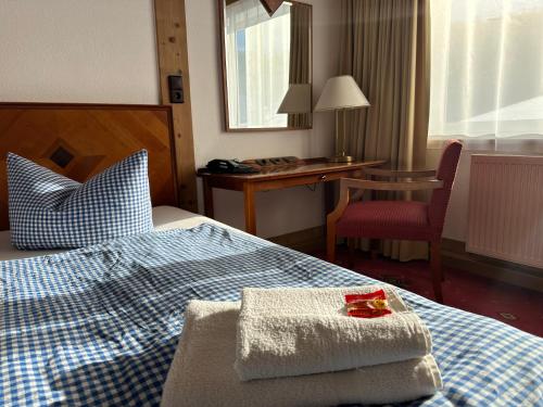 a hotel room with a bed with towels on it at Hotel Söllner in Tettau