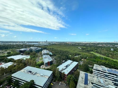 an overhead view of a city with buildings and trees at Best location apartment in Olympic park in Sydney