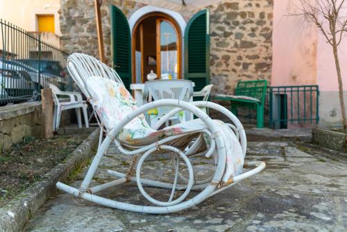 two white rocking chairs sitting outside of a house at Le Balze nel cuore della Toscana in Castelfranco Piandisco