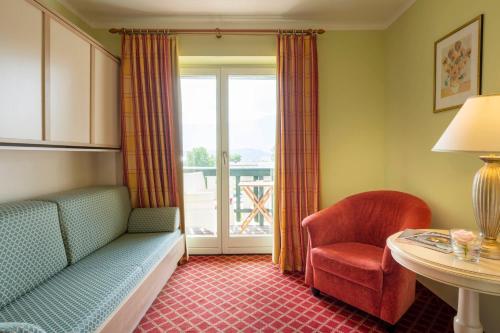 a room with a couch and a chair and a window at Das Moerisch in Seeboden