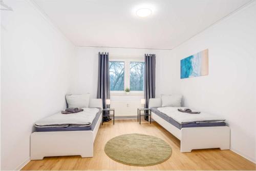 a bedroom with two beds and a window at Modern Apartment near Bottrop in Gladbeck