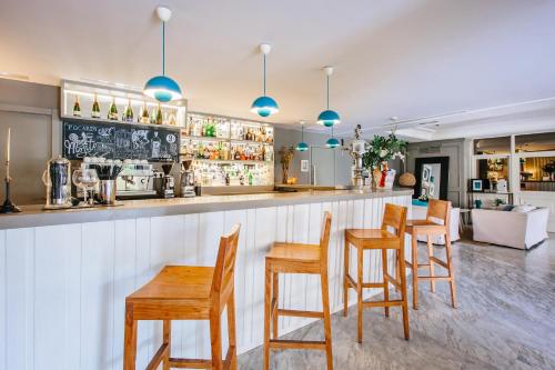 a bar with wooden tables and chairs in a restaurant at Hotel Almirante in Alicante