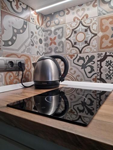 a tea kettle sitting on top of a stove at super apartment on O.Polya 137 in Dnipro