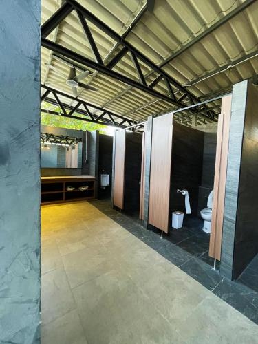 a bathroom with two toilets in a building at The Wild Khao Yai in Klang Dong