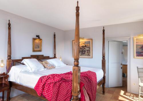 a bedroom with a bed with a red blanket on it at Finca Mas Gotas Costa Brava - BY EMERALD STAY in Vall-Llobrega