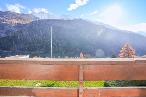 a wooden bench with a view of a mountain at Im Grünen B225 in Mörel