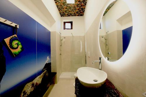 a bathroom with a white toilet and a mirror at Magnifique Villa Azzurra - charme et design in Lipari
