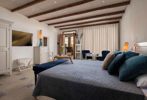 a bedroom with a large bed and a table at Villa Cavalieri Country Hotel in Pula