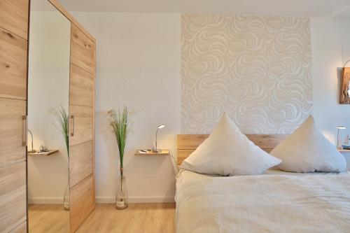 Un pat sau paturi într-o cameră la Strandperle Strandperle Appartement 103
