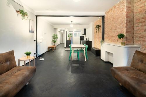 a living room with a couch and a table at Two-Bedroom Apartments in the Heart of Antwerp in Antwerp