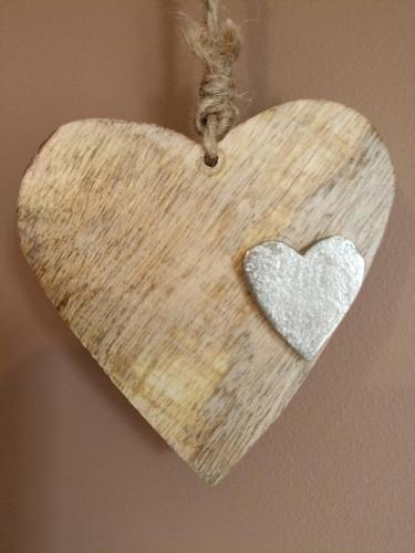 a heart shaped ornament hanging on a wall at Au Coeur d'Acren in Lessines