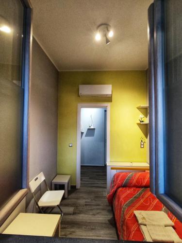 a room with a bed and a hallway with a door at The Junior House - Casa Vacanza in Lauria