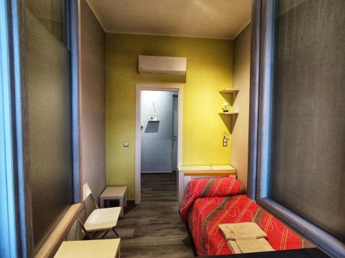 a small room with a bed and a hallway at The Junior House - Casa Vacanza in Lauria