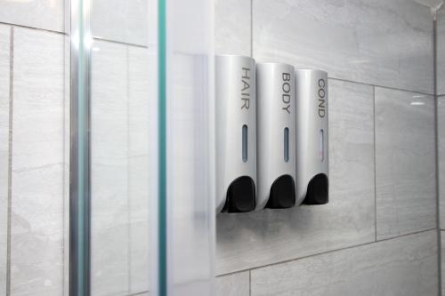 a row of white bottles on a wall at Cosy 2 Bed Flat 1 in Bridgend in Bridgend