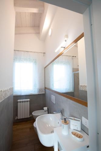 a bathroom with a white sink and a mirror at Agriturismo San Filippo Neri in Castignano