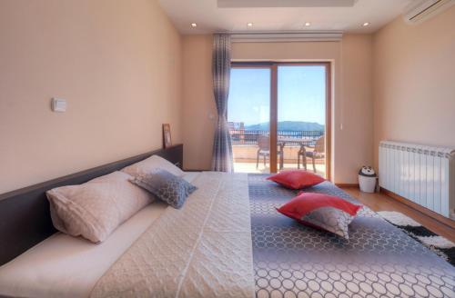 a bedroom with a large bed with two pillows at Vila Plima in Becici