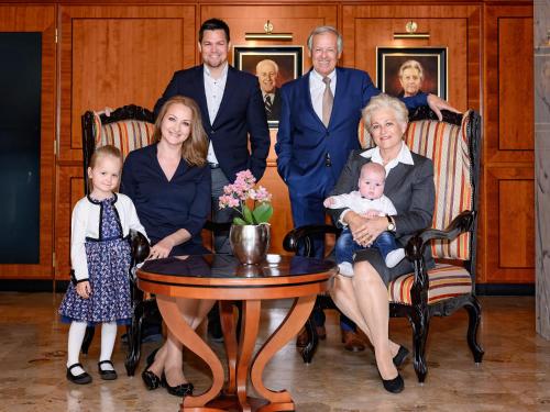 a family posing for a picture in a room at Parkhotel Graz - Traditional Luxury in Graz