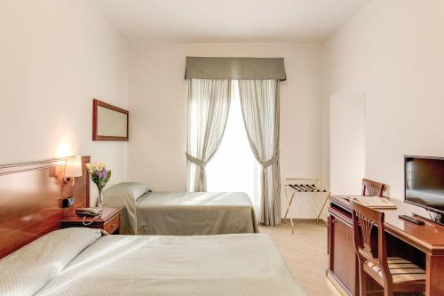 Postel nebo postele na pokoji v ubytování Hotel Flavio