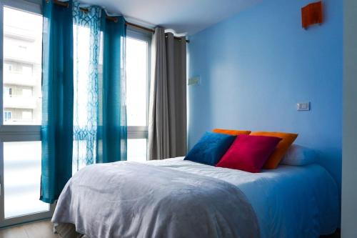 una camera blu con un letto con cuscini colorati di Blue Batayola Pool a Candelaria