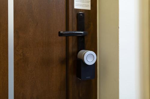a door handle with a roll of paper on it at Casa Luxury Wellness Apartman By BLTN in Siófok