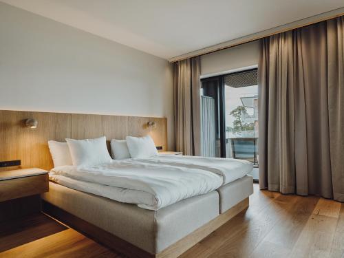 a bedroom with a large bed and a large window at Åhus Seaside in Åhus