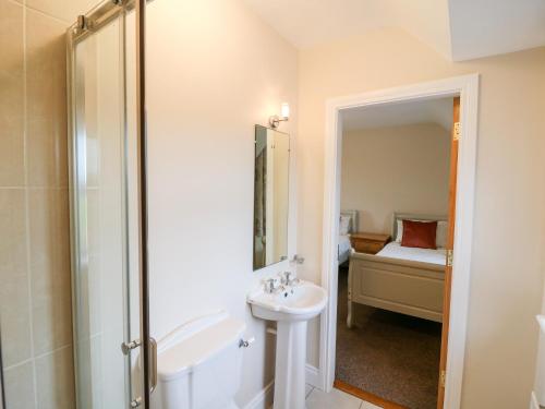 a bathroom with a shower and a sink and a tub at Ballycahane in Castletownshend