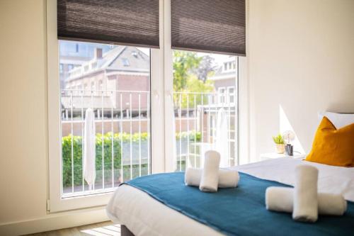 a bedroom with a bed and a large window at Lovely 3 Bedroom Apartment in Eindhoven 65m2 in Eindhoven
