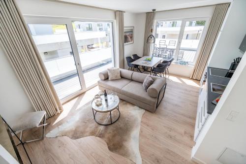 a living room with a couch and a table at Villa Zweite Heimat - Exklusive Penthouse No 4 in Lohme