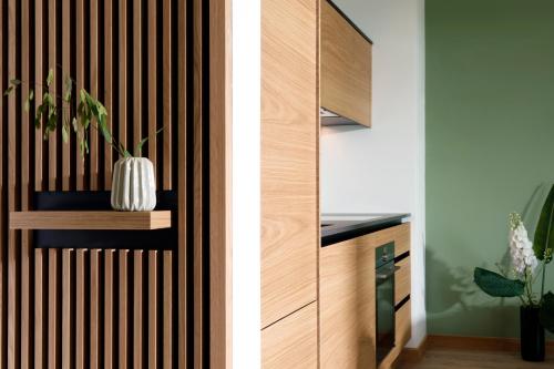 a wooden wall with a vase on a shelf at Villa am Schloss Ranzow L3 Lohme Luxury Living in Lohme