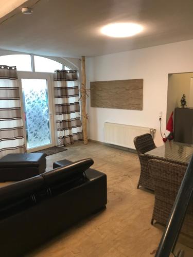 a living room with a couch and a table at Kranenbruch in Schwalmtal